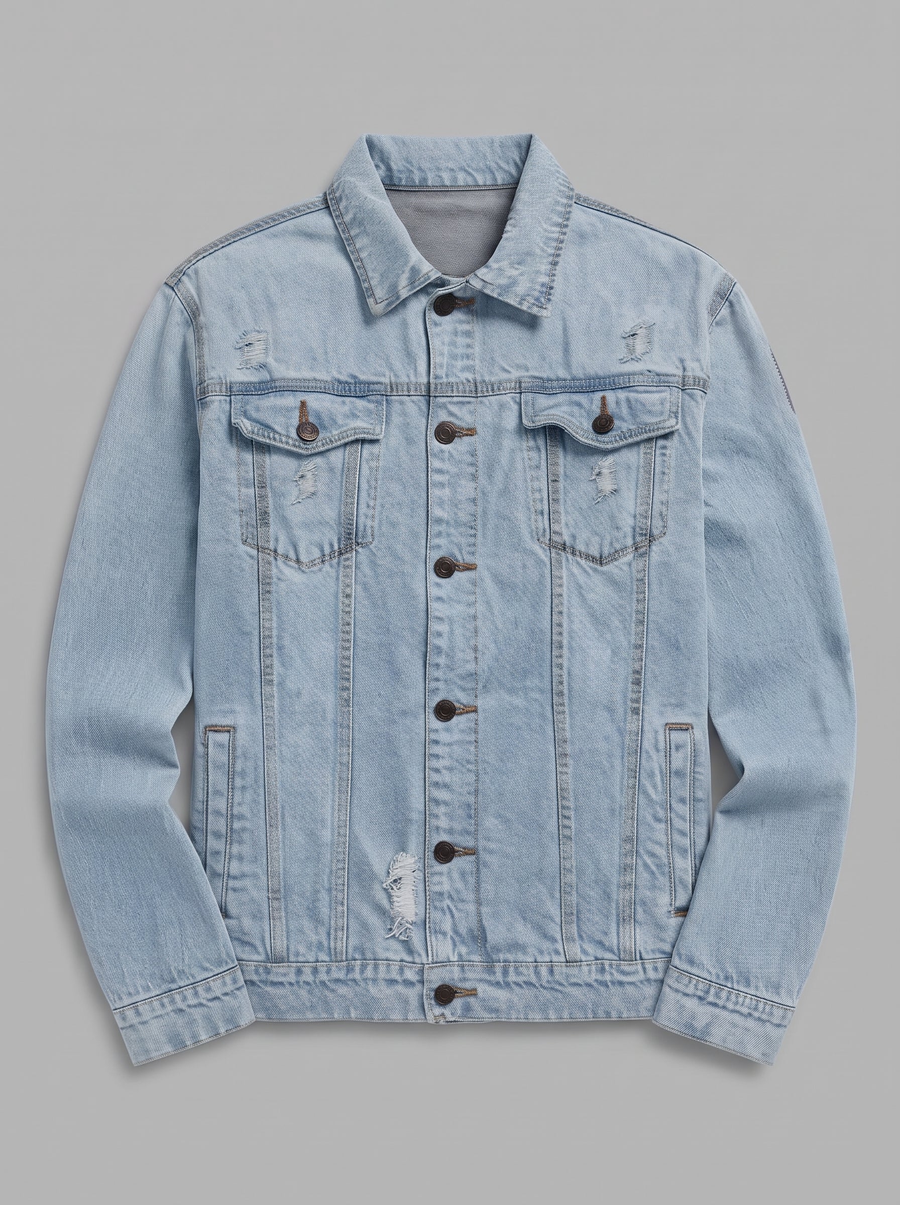A light blue distressed denim trucker jacket with button-front closure, flap chest pockets, and side pockets, shown flat against a solid gray background.