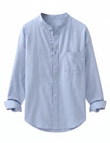 A light blue long-sleeve button-up shirt with a mandarin collar and a chest pocket, shown on a plain white background.