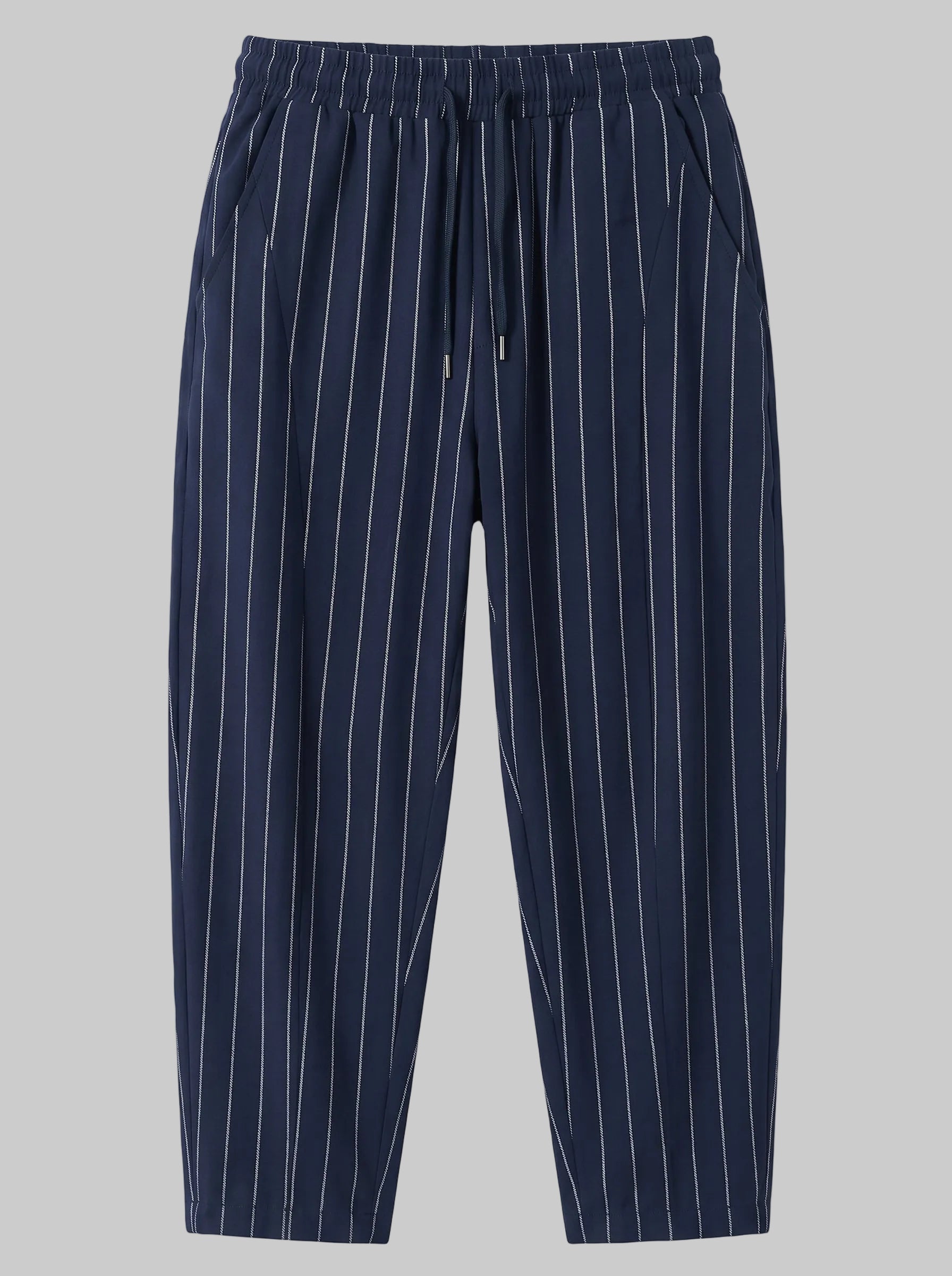 A pair of navy blue drawstring trousers with thin white vertical pinstripes, shown flat against a solid white background.