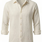 Beige button-up shirt with a subtle pattern on a white background