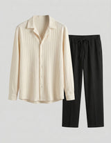 Beige long-sleeve shirt and black pants on a light gray background