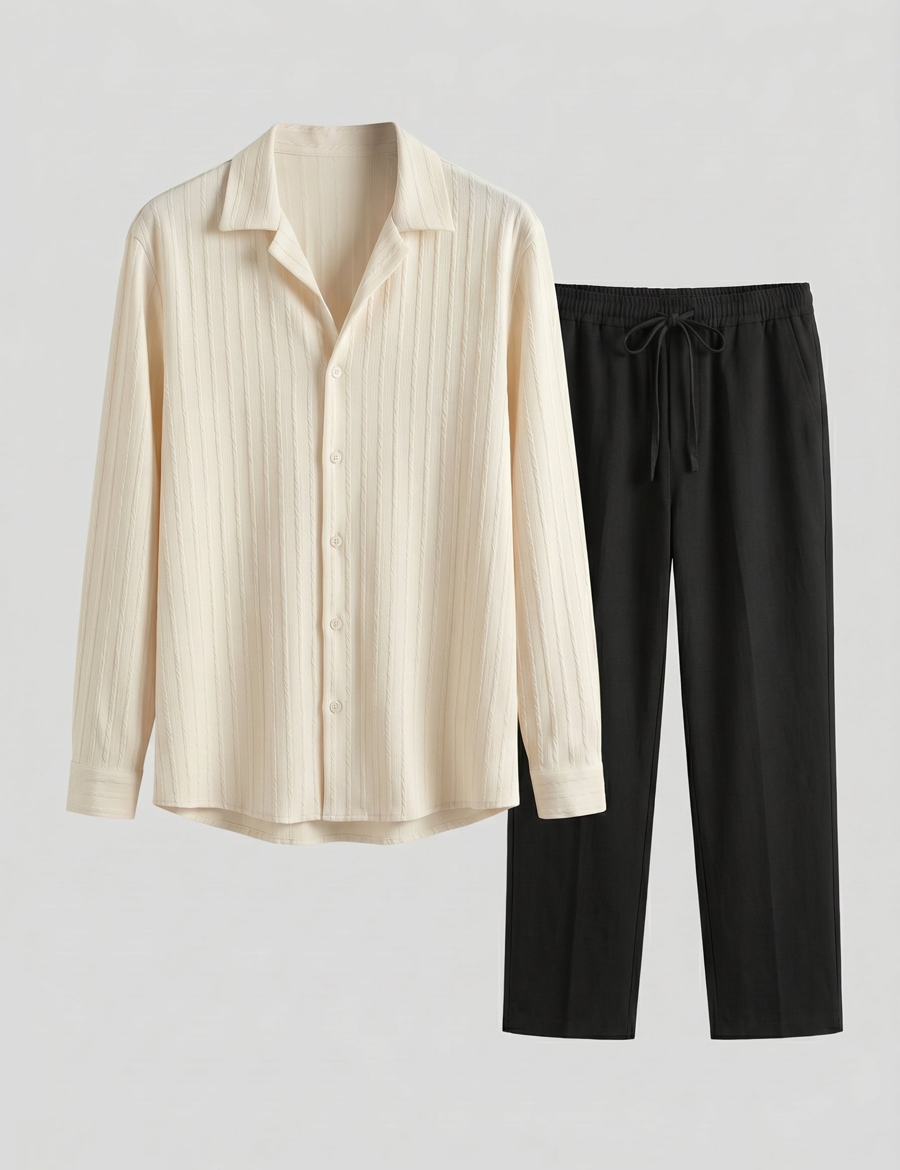 Beige long-sleeve shirt and black pants on a light gray background
