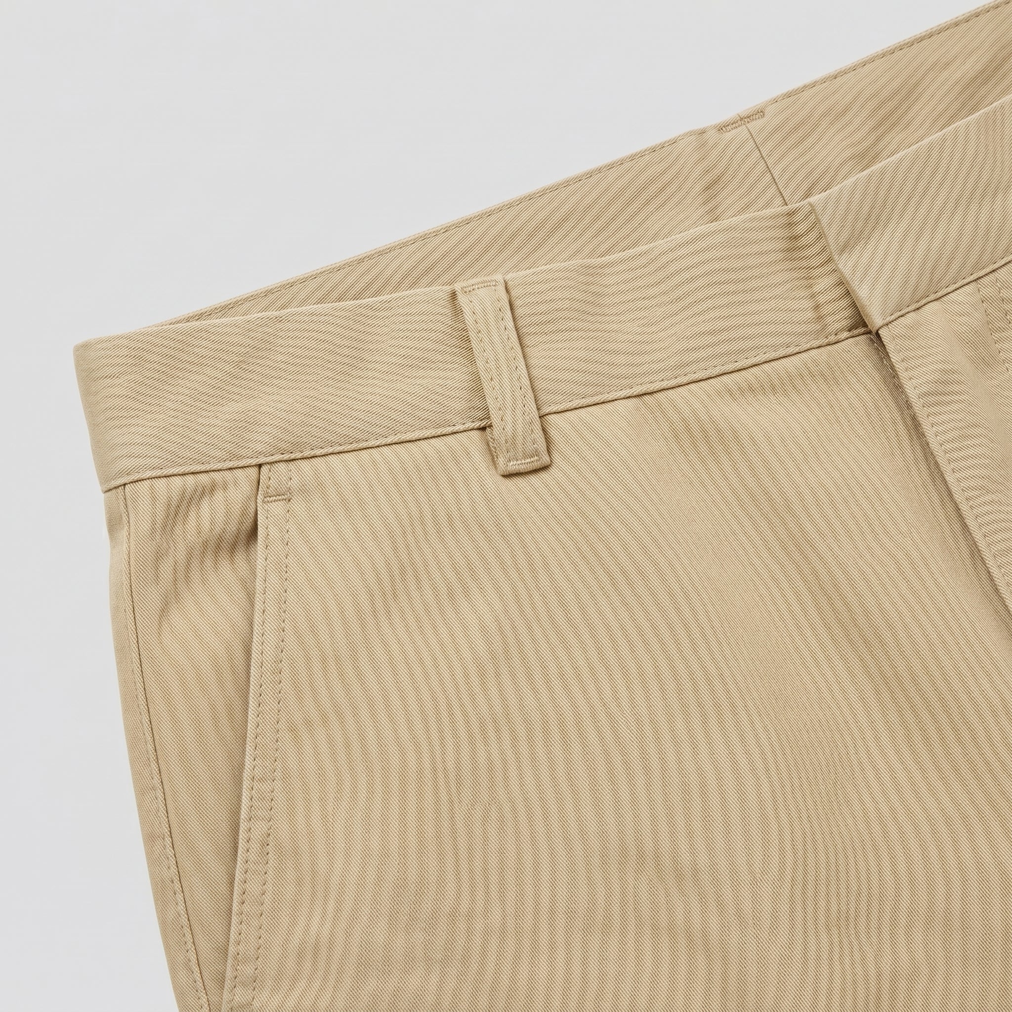 Beige men’s straight fit trousers with button waistband close-up details