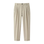 Beige pleated casual pants with tapered legs on a white background.