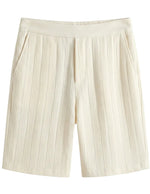 Beige pleated shorts on a light gray background