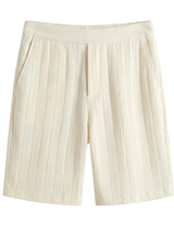 Beige pleated shorts on a light gray background