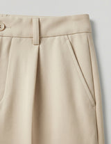 Beige pleated skirt on a light gray background