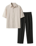 Beige shirt and black pants on a light gray background