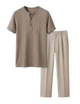 Beige shirt and pants set on a light gray background