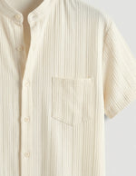 Beige short-sleeve shirt on a light gray background
