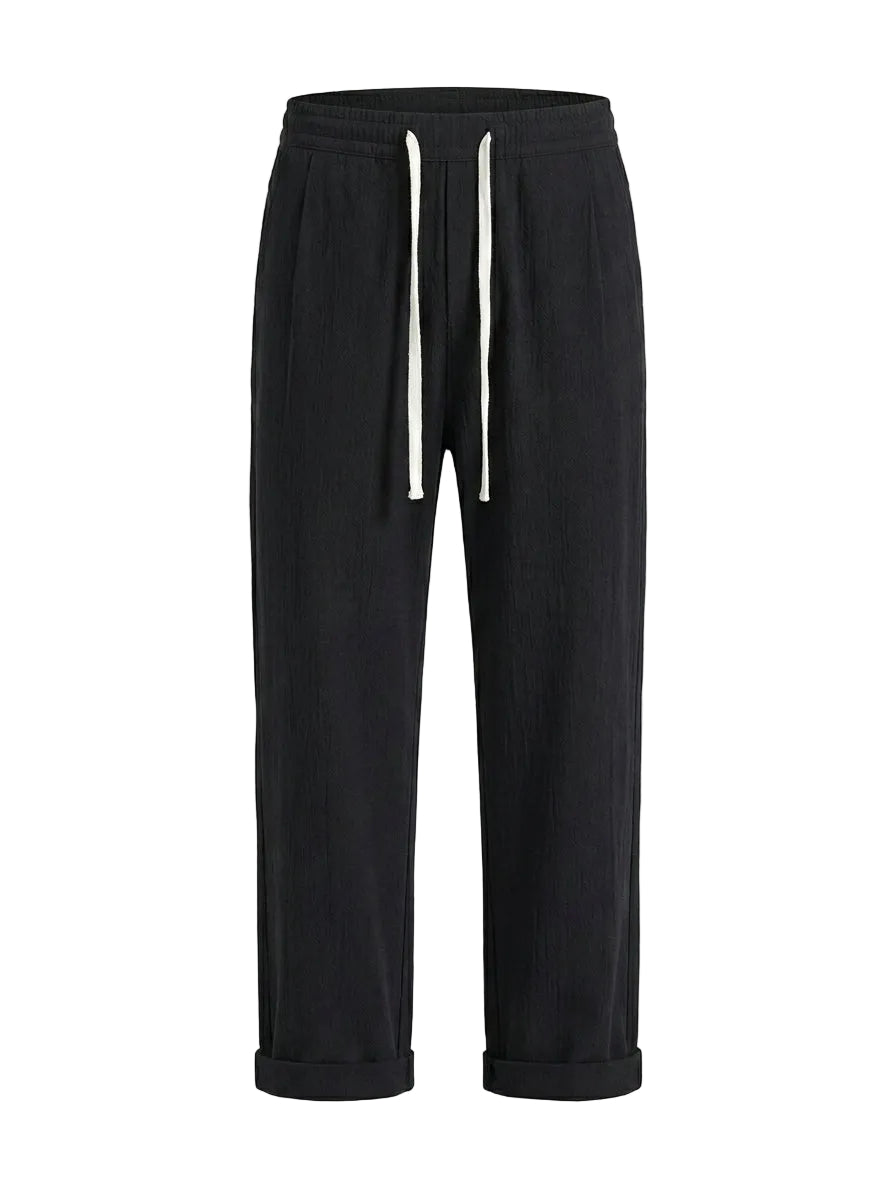 Black drawstring jogger pants with tapered legs on a white background.