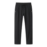 Black jogger pants with elastic waistband and tapered legs on a white background.