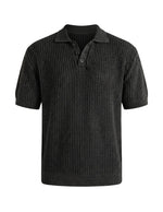 Black knitted polo shirt on a light gray background
