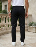 Black men’s lightweight drawstring pants with elastic waistband and clean casual fit back view