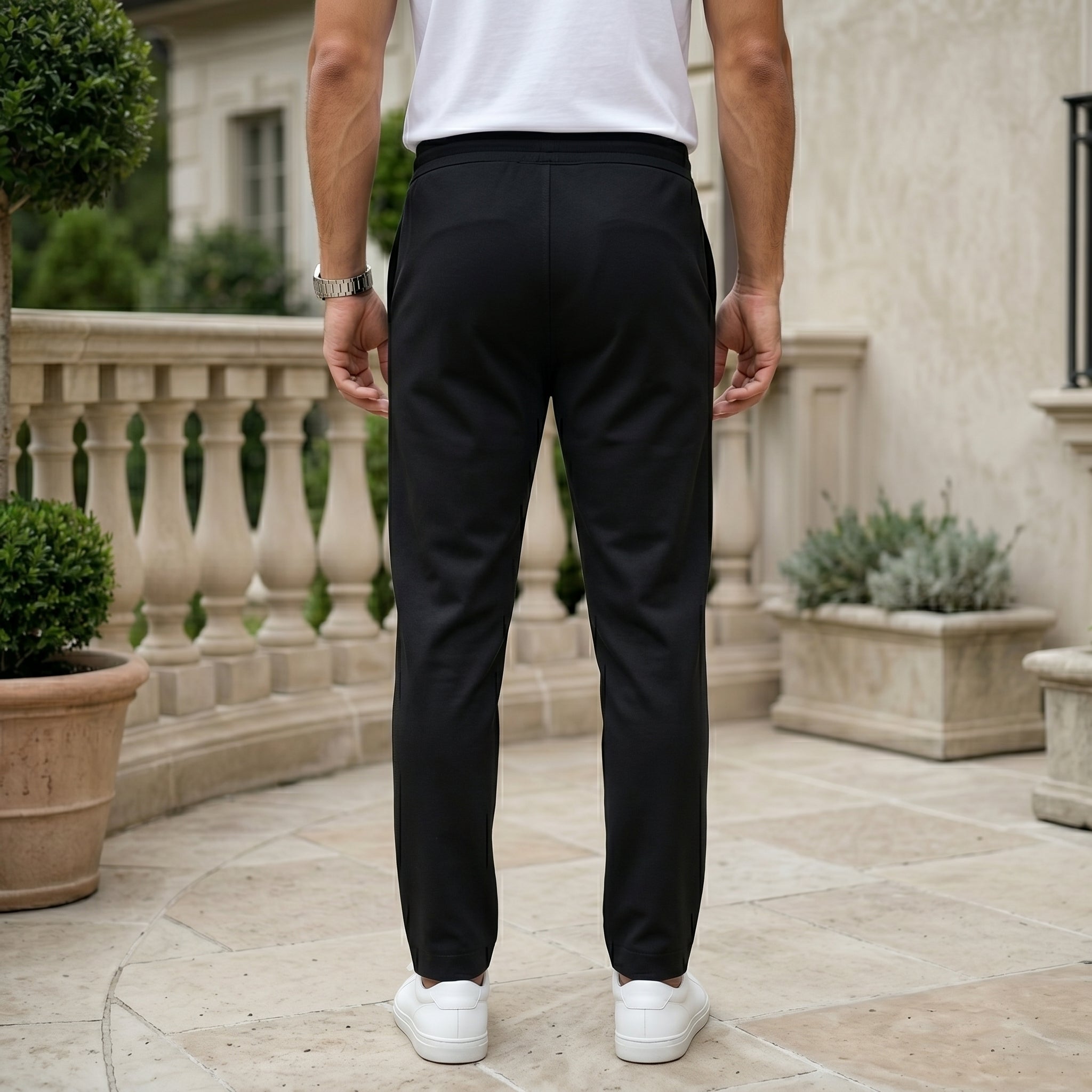 Black men’s lightweight drawstring pants with elastic waistband and clean casual fit back view