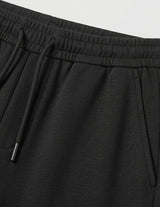 Black men’s lightweight drawstring pants with elastic waistband and clean casual fit close-up details