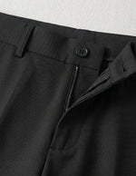 Black men’s pleated tailored pants with clean front closure and straight fit close-up details