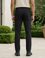 Black men’s stretch pocketed pants with clean straight fit and button-front closure back view