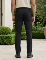Black men’s stretch pocketed pants with clean straight fit and button-front closure back view