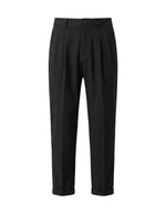 Black pleated tailored pants with straight legs on a white background.