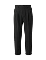 Black pleated tailored pants with straight legs on a white background.