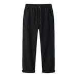 Black relaxed-fit casual pants on a white background.