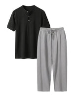Black shirt and gray pants set on a white background