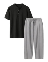 Black shirt and gray pants set on a white background