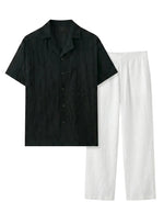 Black short-sleeve shirt and white pants on a white background