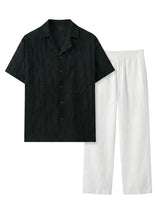 Black short-sleeve shirt and white pants on a white background