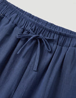 Blue pants with a drawstring on a light gray background