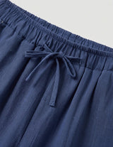 Blue pants with a drawstring on a light gray background