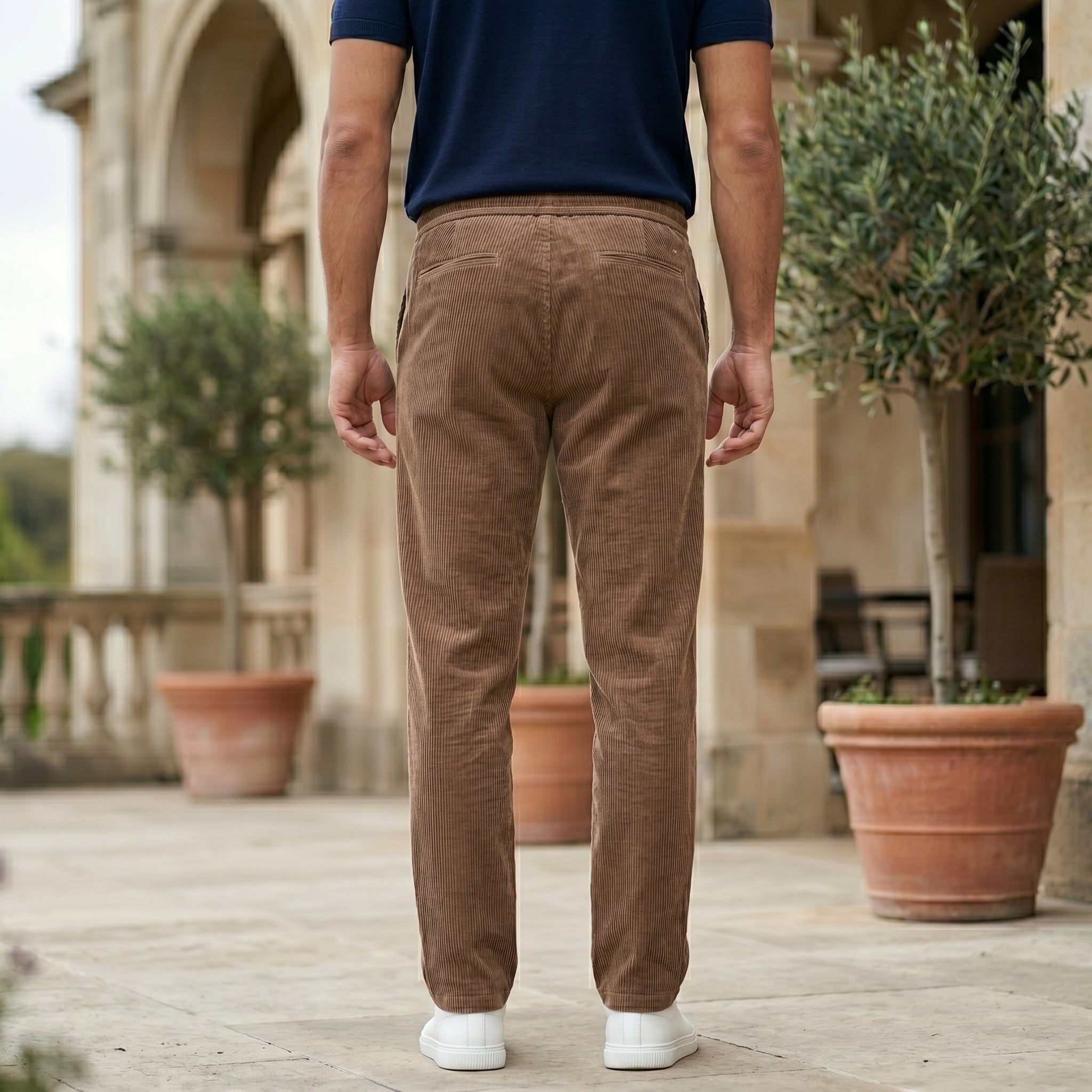 Brown men’s ribbed drawstring pants with elastic waistband and side pockets back view