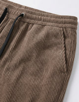 Brown men’s ribbed drawstring pants with elastic waistband and side pockets close-up details
