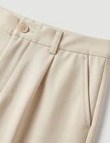 Celeste - Beige pants with a button on a light gray background