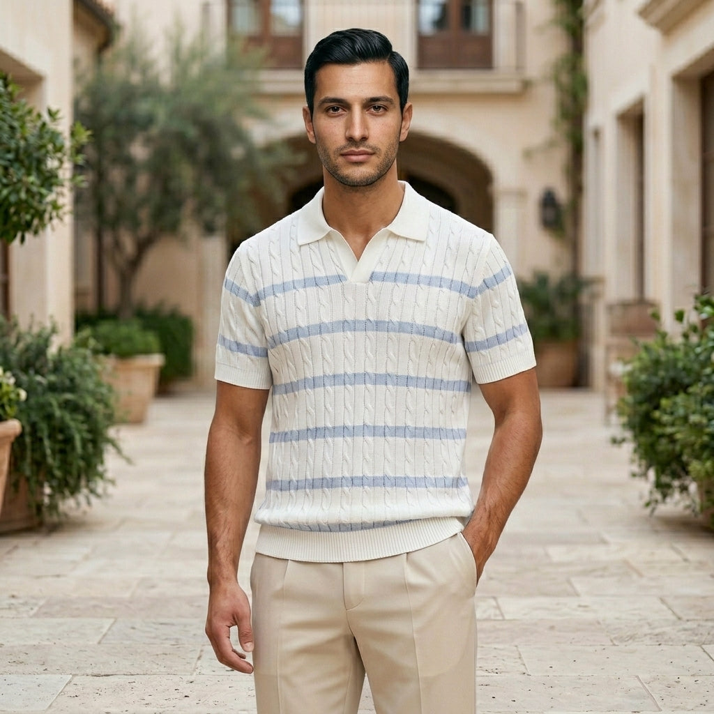 Celeste - Man wearing a striped polo shirt and beige pants standing in an outdoor setting with buildings and plants.