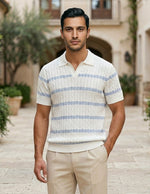 Celeste - Man wearing a striped polo shirt and beige pants standing in an outdoor setting with buildings and plants.