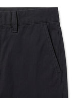 Close-up detail of black casual pants waistband, button closure, and soft fabric.