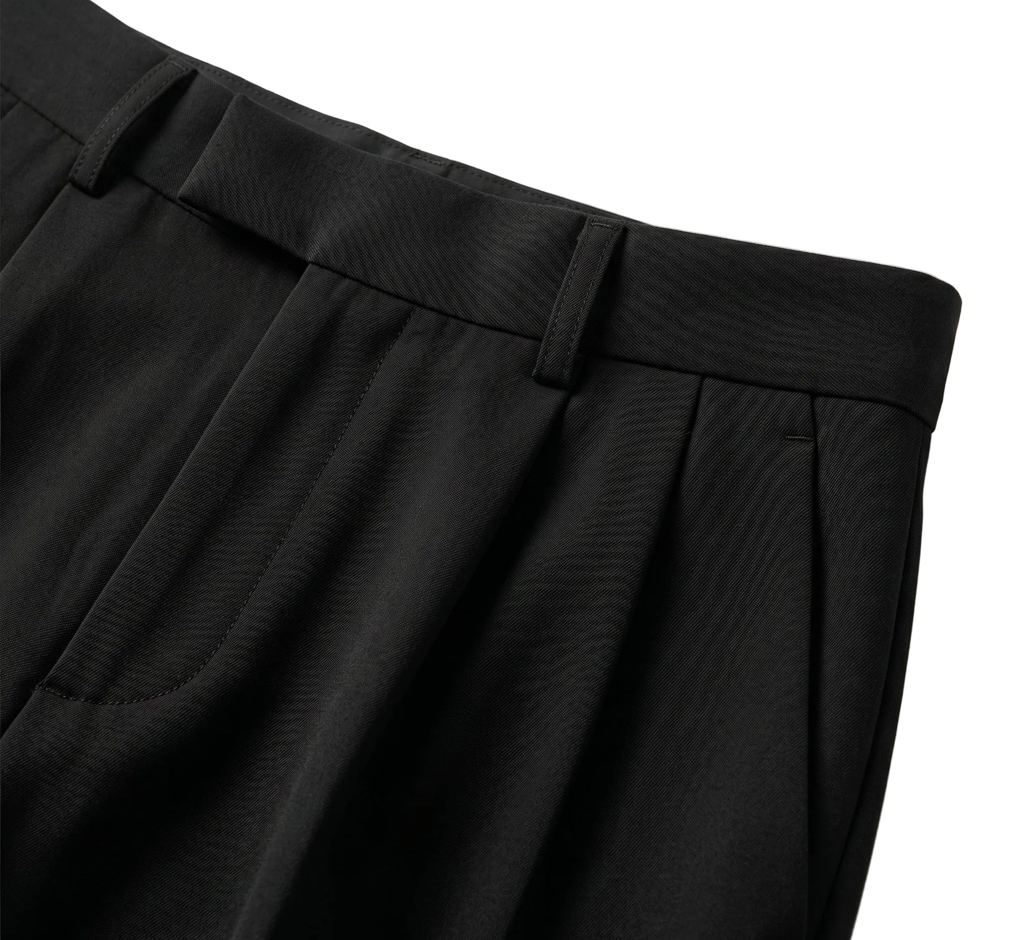 Close-up detail of black pleated pants waistband with button closure and soft fabric.