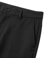 Close-up detail of black tailored pants waistband with belt loops, button closure, and smooth fabric.