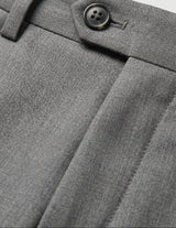 Close-up detail of gray pleated pants waistband with belt loops, button closure, and smooth fabric.