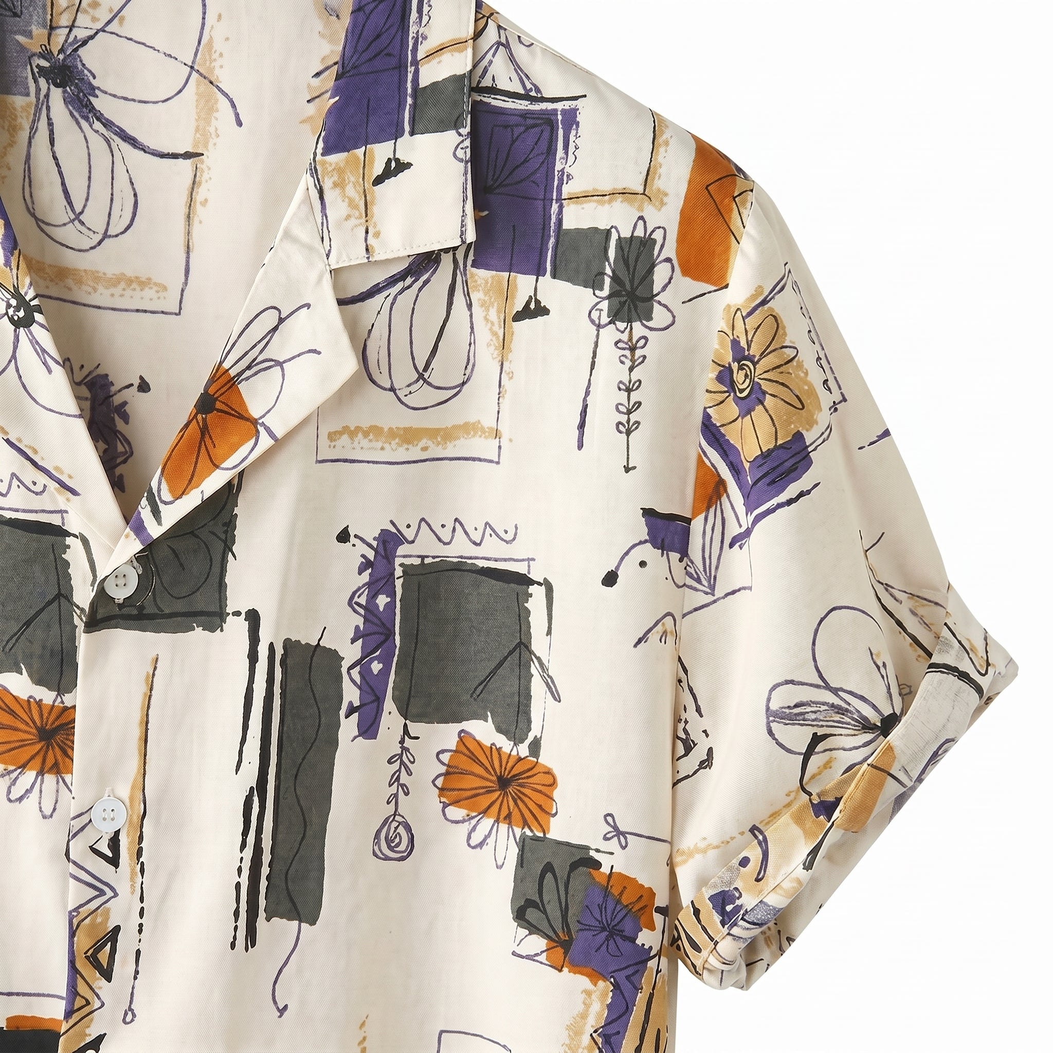 Close-up detail of ivory abstract print short-sleeve- button-up shirt fabric and collar.