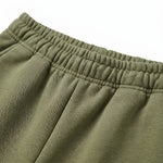 Close-up detail of olive green hoodie front pocket and drawstring hood.