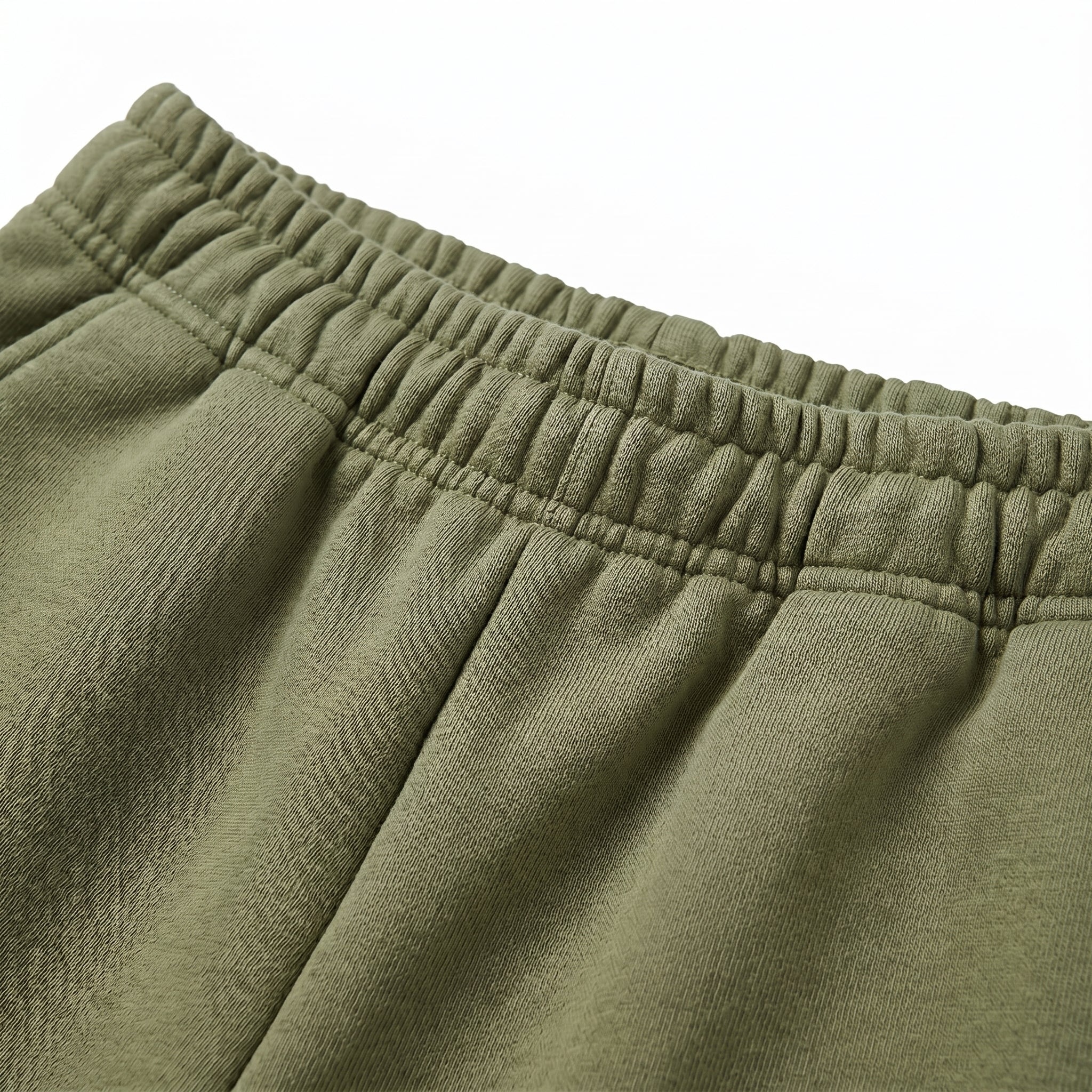 Close-up detail of olive green hoodie front pocket and drawstring hood.