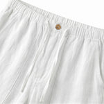 Close-up detail of white casual pants waistband with button closure and soft textured fabric.