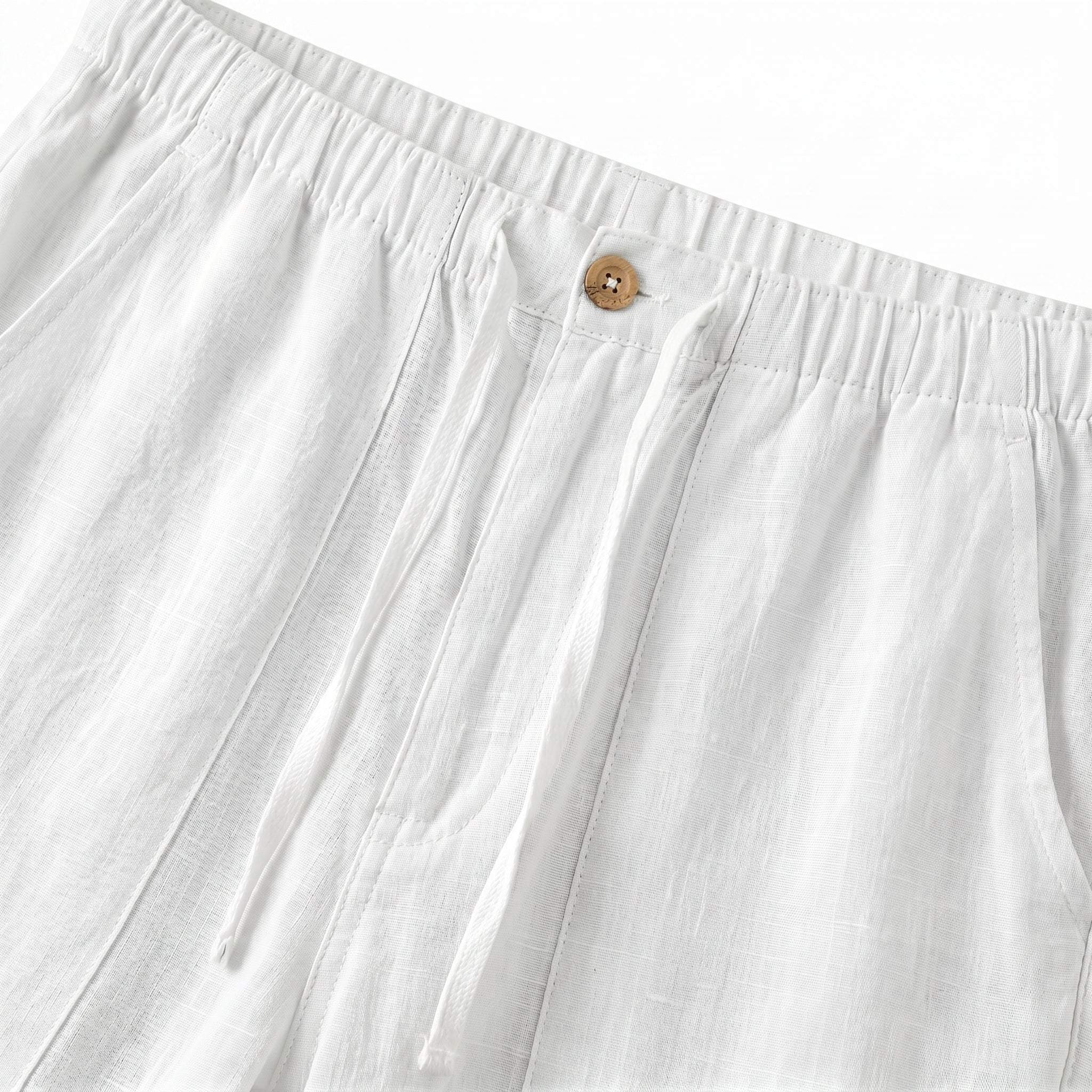 Close-up detail of white casual pants waistband with button closure and soft textured fabric.