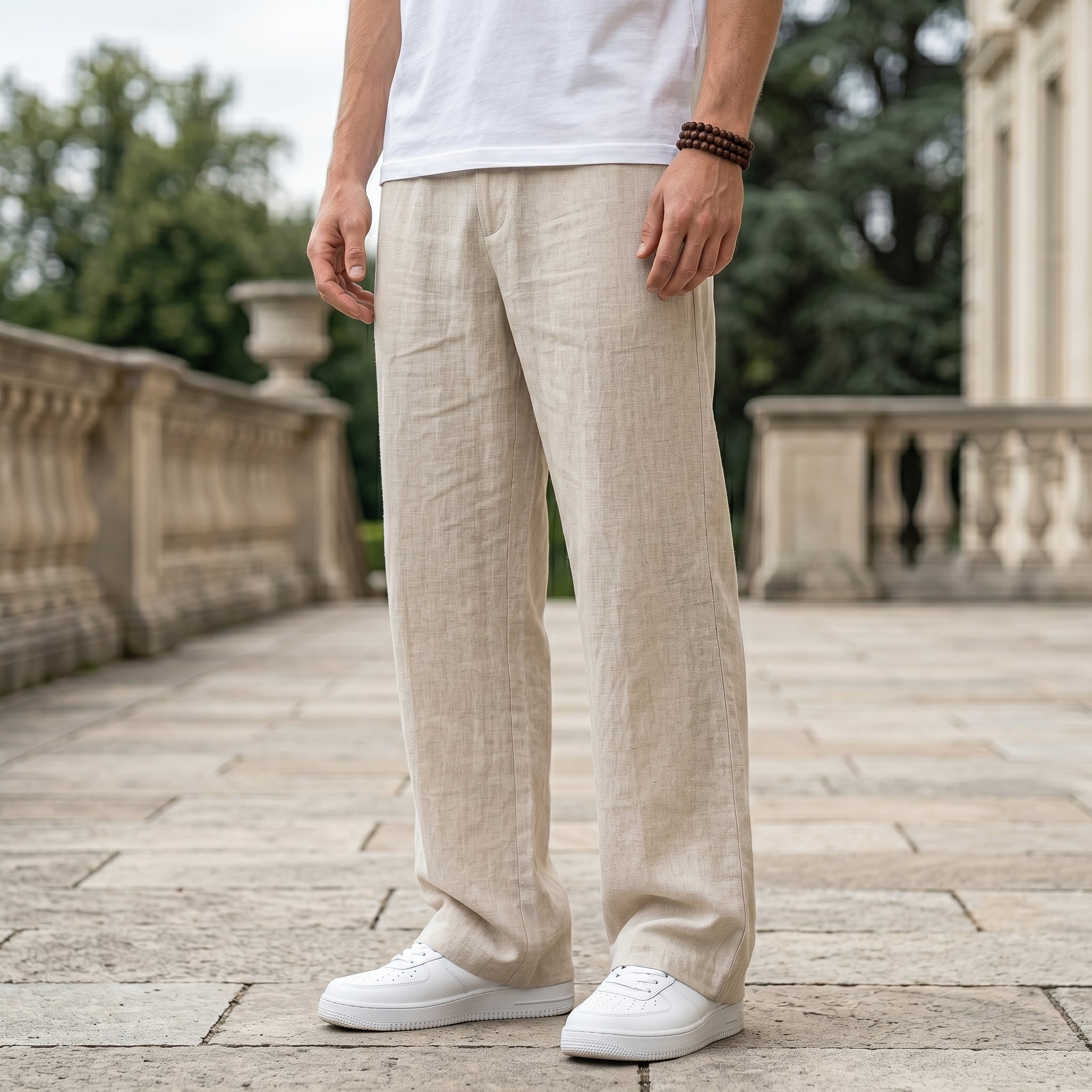 Close-up front view of male model wearing beige textured relaxed-fit pants with a straight-leg fit.