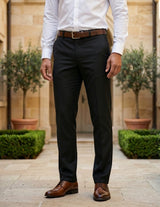 Close-up front view of male model wearing black tailored dress pants with a slim straight-leg fit.