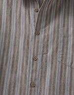 Close-up of a brown and blue striped shirt with button details