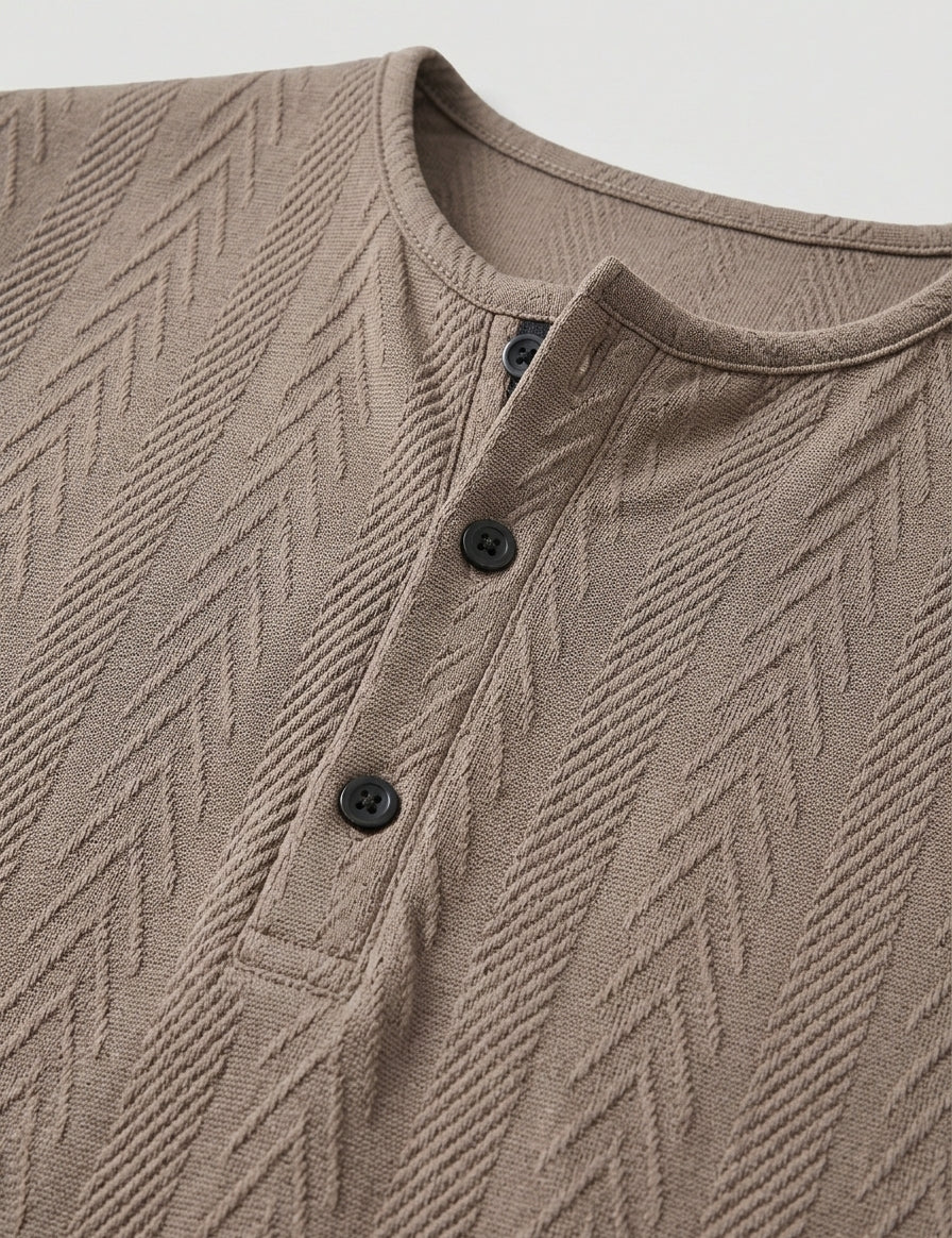 Close-up of a brown textured shirt with buttons on a light gray background